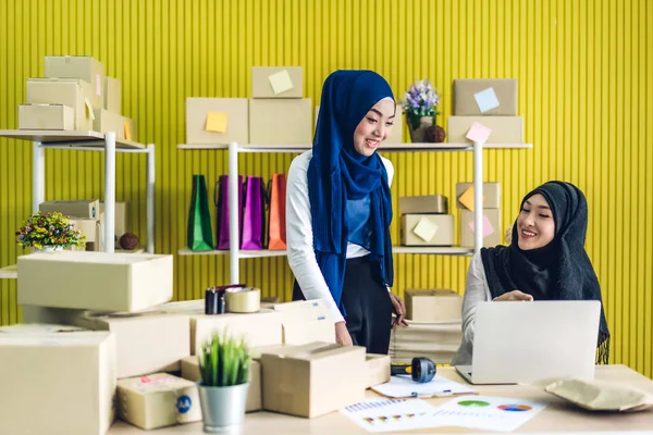 美しい笑顔の肖像画2人のイスラム教徒の所有者アジアの女性フリーランスいくつかのビジネスオンラインショッピング自宅でテーブルの上に小包ボックスとラップトップコンピュータ上で作業 ビジネスオンライン配送 — ストック写真