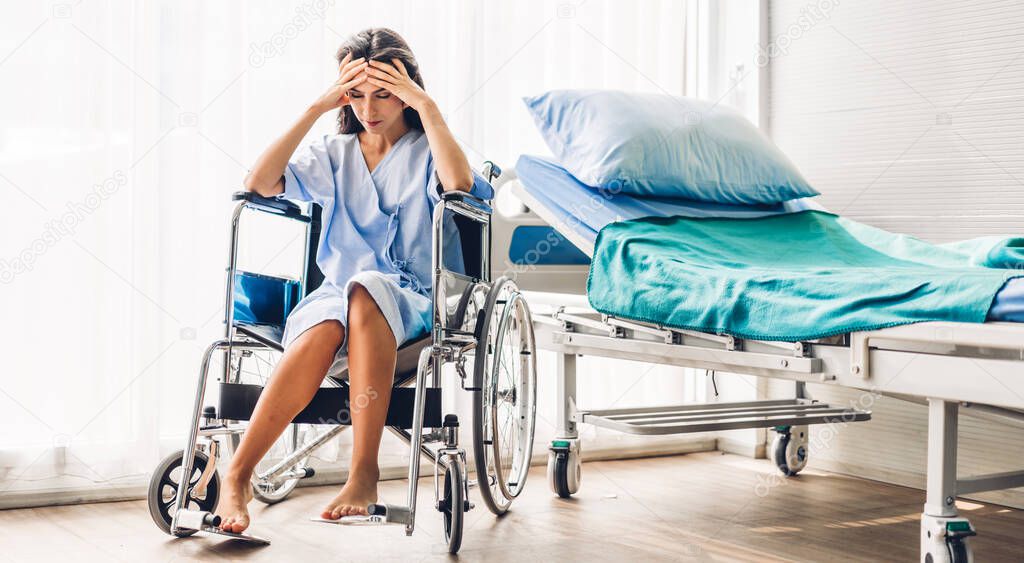 Woman patient serious depressed and feeling headache sit on wheelchair in hospital.healthcare and medicine