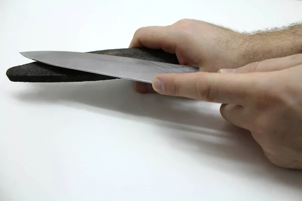 Руки з щебенем і ножем ізольовані на сірому фоні — стокове фото