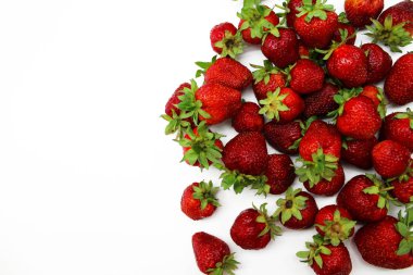 Olgun kırmızı çilek beyaz bir arka plan üzerinde dağınık.