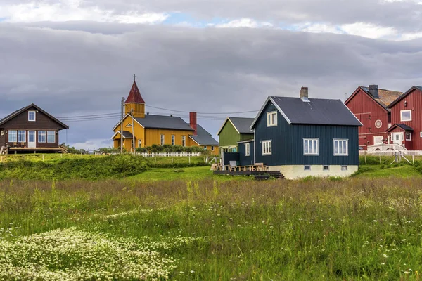 Wooden church and cottages of Skallev village in Vadso Municipal Stock Image