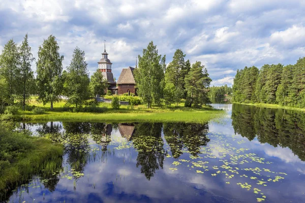 Old wooden church of Petajavesi village is a part of natural env Royalty Free Stock Images