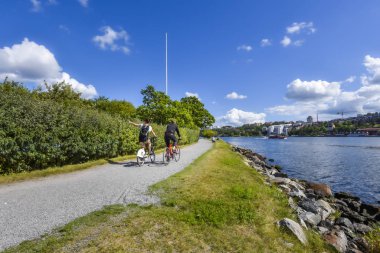 Cent 'teki Curgarden Adası' nda su kenarında gezinen bisikletçi.