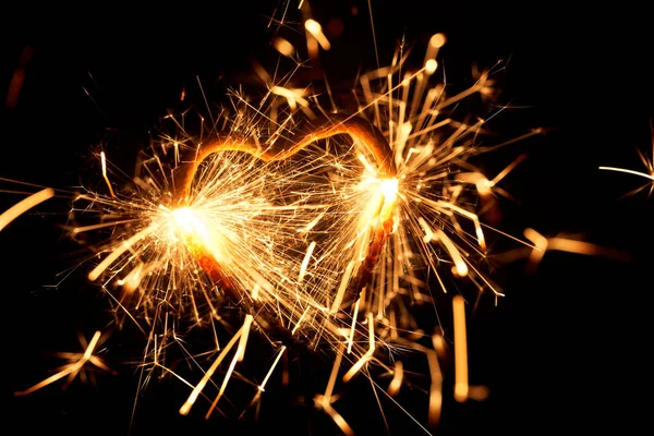 Burning sparkler in form of a heart — Stock Photo, Image