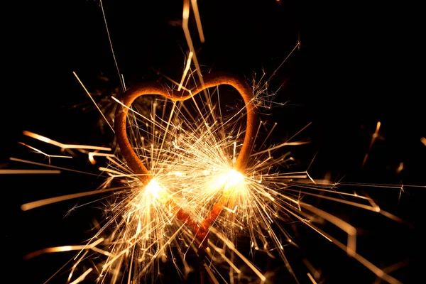 Burning sparkler in form of a heart — Stock Photo, Image