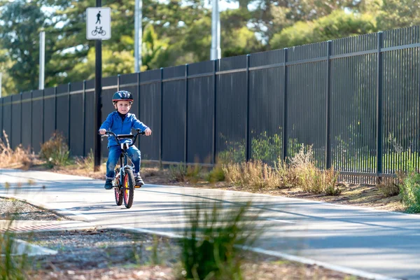 Happy boy riding his bicycle on bike lane — ストック写真