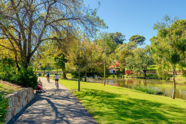 People riding bikes along Torrens river