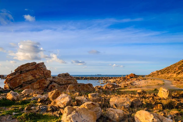 Pathway along the sea at sunset — Stock Photo, Image