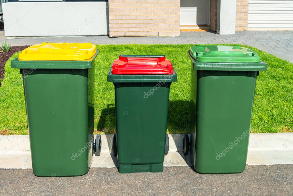 Home waste wheelie bins set on front yard