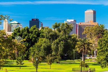 Adelaide, Australia - February 23, 2020: Adelaide city skyline viewed through Pennington Gardens on a day clipart