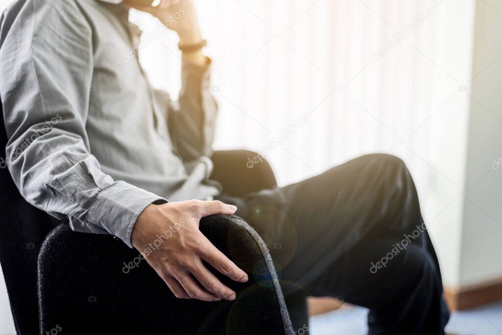 Close up Business Man Hands Sitting on Black Chair in Office Roo