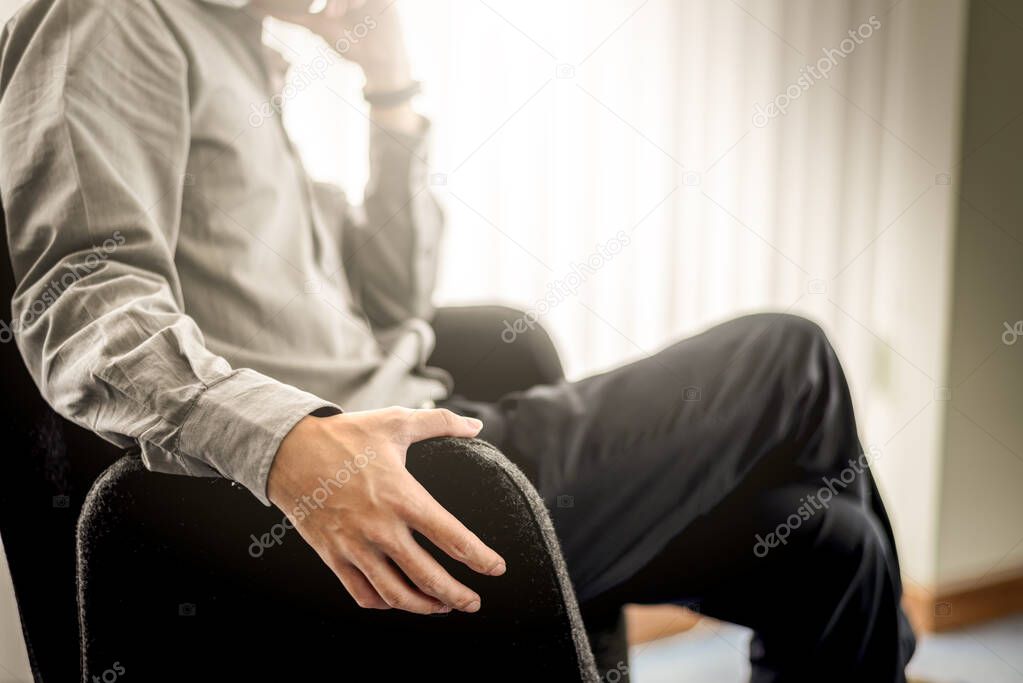 Close up Business Man Hands Sitting on Black Chair in Office Roo