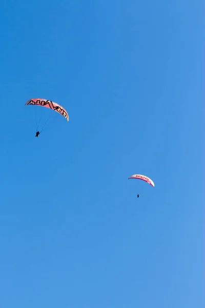 Sky Diving with space in solid blue sky