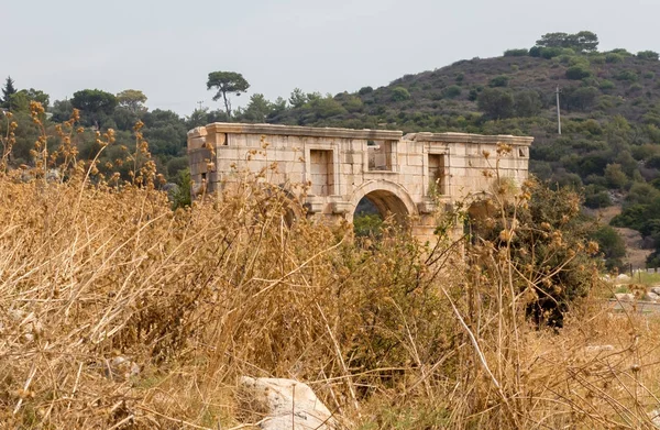 The Triumphal Arch of Metius Modestus welcomes visitors at the entrance to the Patara site,