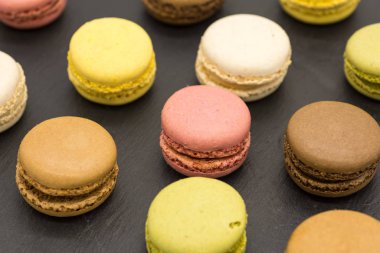 Delicious assorted macarons arranged on a slate