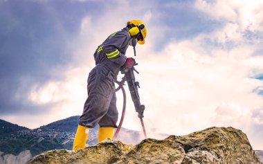 Worker on top of a rock clipart