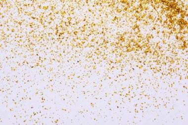 Golden glitter texture on white abstract background