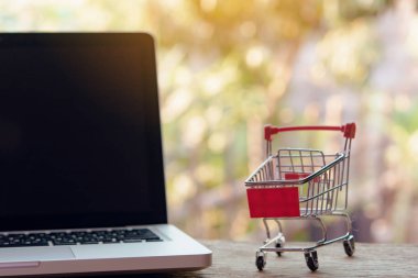 Shopping online concept - Empty shopping cart or trolley on a la