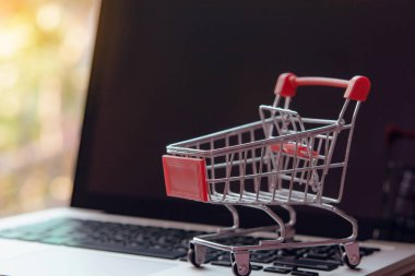 Shopping online concept - Empty shopping cart or trolley on a la