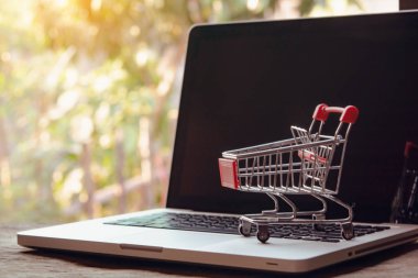 Shopping online concept - Empty shopping cart or trolley on a la