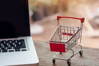 Shopping online concept - Empty shopping cart or trolley on a la