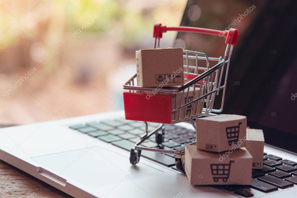 Shopping online concept - Parcel or Paper cartons with a shoppin