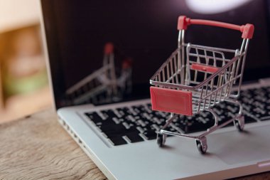 Shopping online concept - Empty shopping cart or trolley on a la