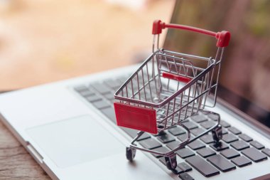 Shopping online concept - Empty shopping cart or trolley on a la