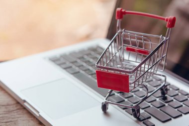 Shopping online concept - Empty shopping cart or trolley on a la