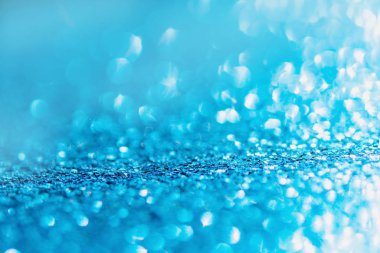 Defocused blue glitter background. blue abstract bokeh backgroun