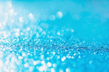 Defocused blue glitter background. blue abstract bokeh backgroun