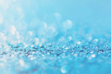 Defocused blue glitter background. blue abstract bokeh backgroun