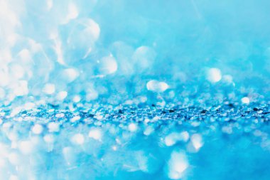 Defocused blue glitter background. blue abstract bokeh backgroun