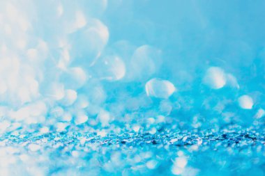 Defocused blue glitter background. blue abstract bokeh backgroun