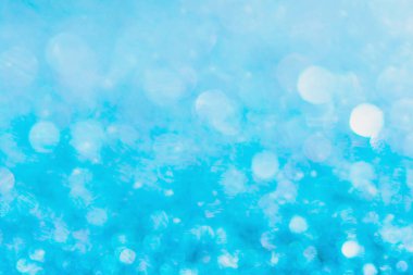 Defocused blue glitter background. blue abstract bokeh backgroun