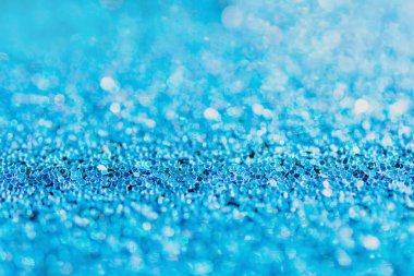 Defocused blue glitter background. blue abstract bokeh backgroun
