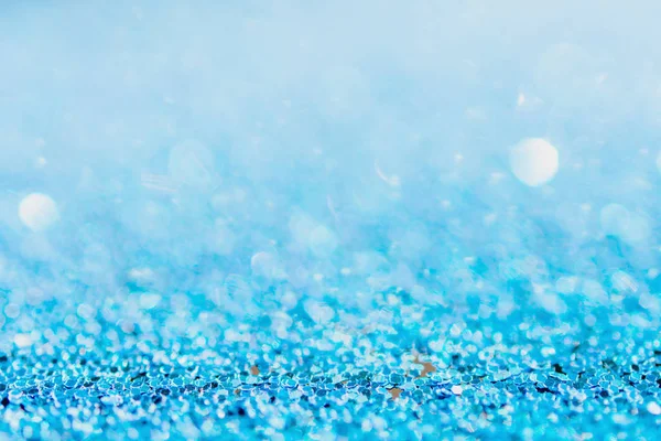 Defocused blue glitter background. blue abstract bokeh backgroun