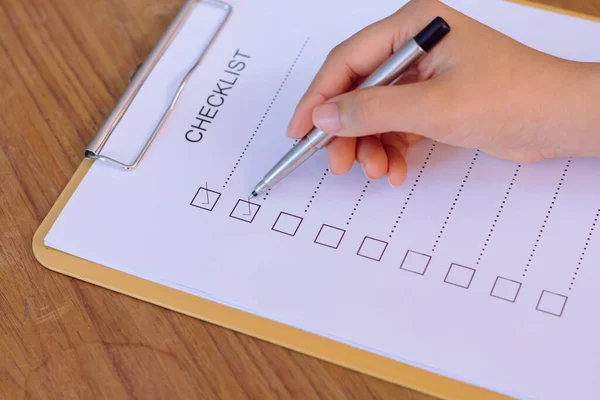 image of businessfemale preparing checklist at office desk