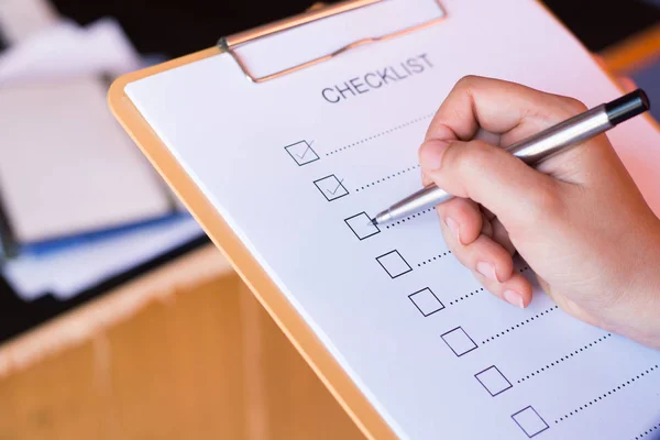 image of businessfemale preparing checklist at office desk