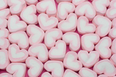 Pink heart shaped marshmallows background