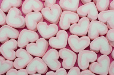 Pink heart shaped marshmallows background