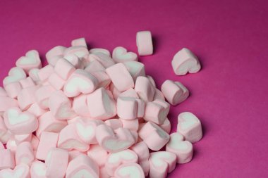 Pink heart shaped marshmallows background