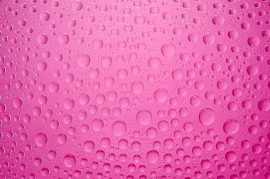 Water drops pink background. Water drops on glass background