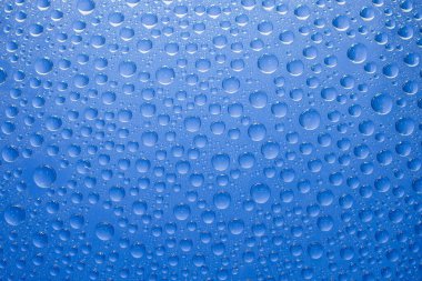 Water drops blue background. Water drops on glass background