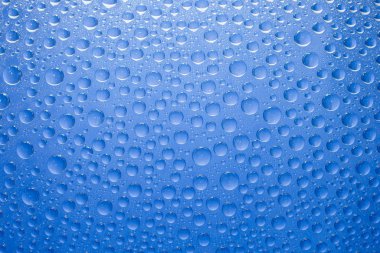 Water drops blue background. Water drops on glass background
