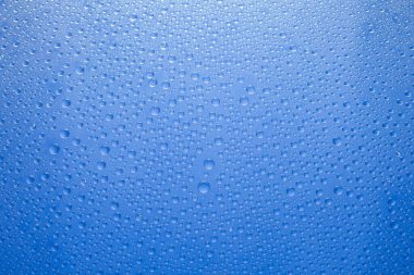 Water drops blue background. Water drops on glass background