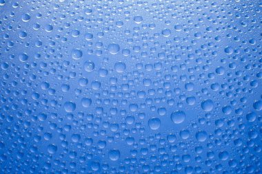 Water drops blue background. Water drops on glass background