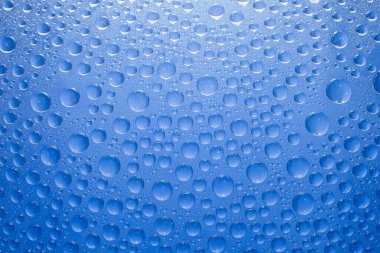 Water drops blue background. Water drops on glass background