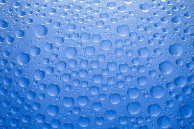 Water drops blue background. Water drops on glass background