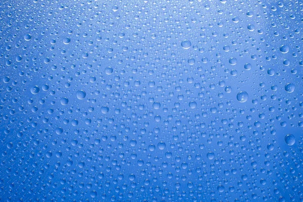 Water Druppels Blauwe Achtergrond Waterdruppels Glazen Ondergrond — Stockfoto